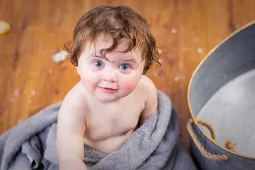 Clean portrait of a one-year-old taken at the start of a cake smash session