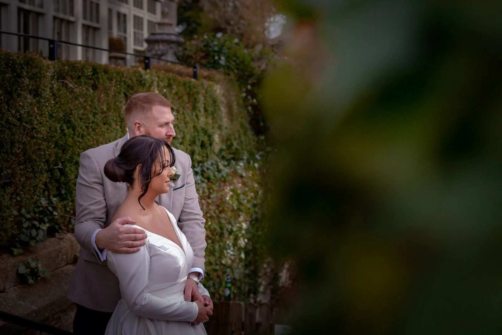 Bride and groom embracing in a garden at a Lancashire wedding