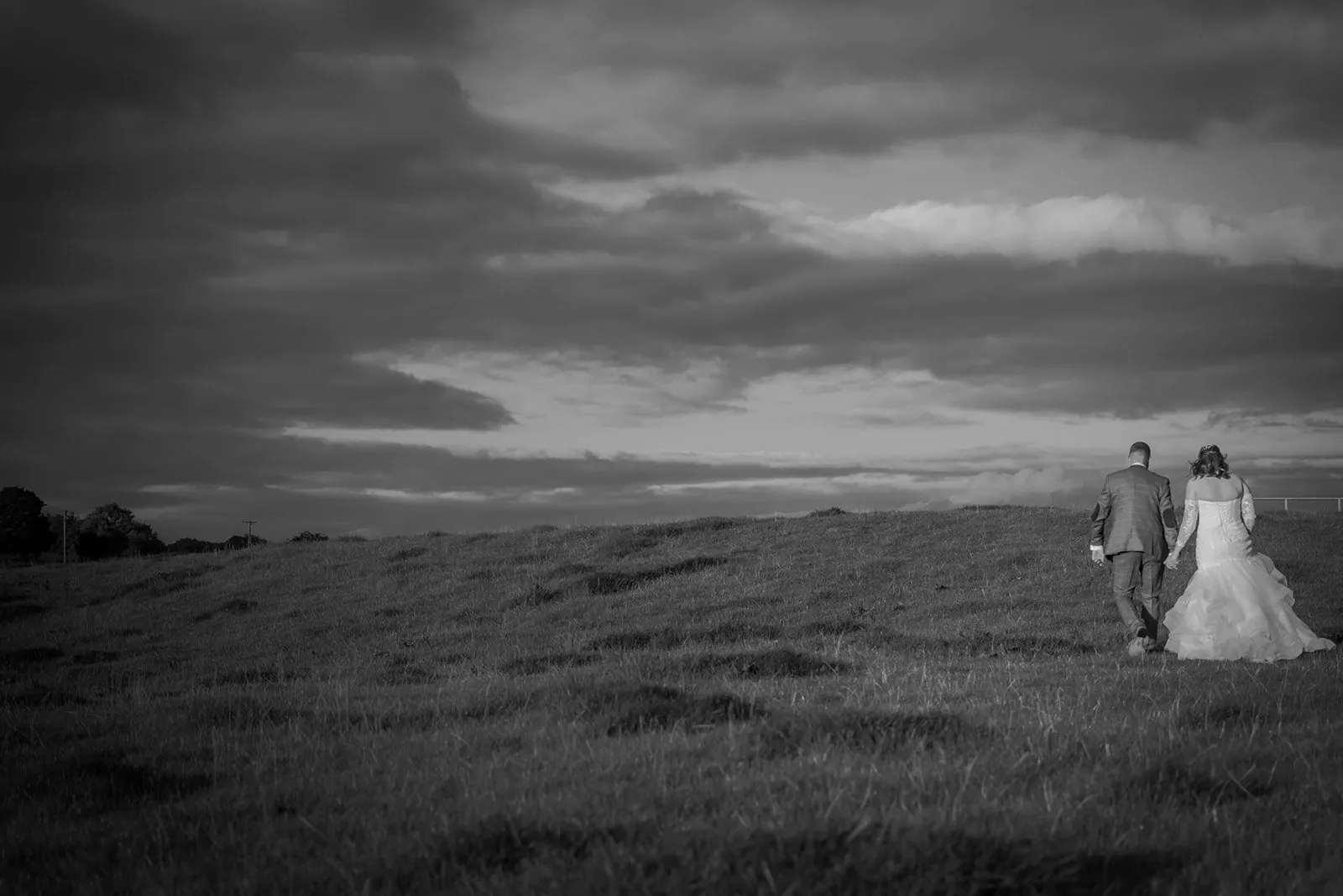 Black and white photograph of a bride and groom in open Lancashire moorland