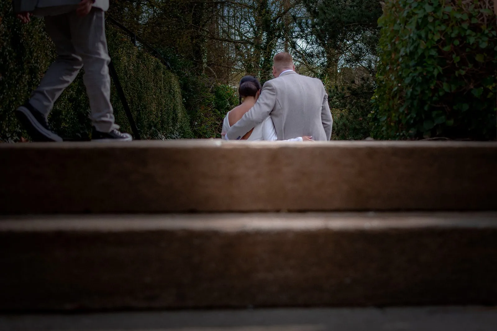 Bride and groom sitting together on stone steps at a Lancashire wedding