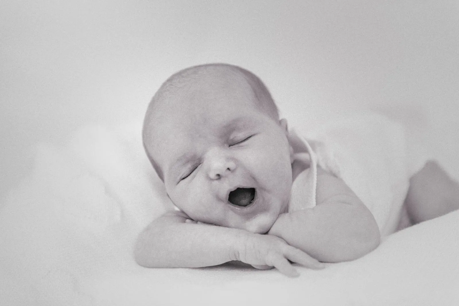 Newborn mid-yawn, one of the expressions worth waiting quietly for